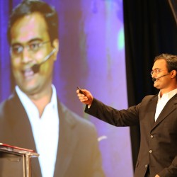 Praveen Narra sharing stage with Steve Forbes