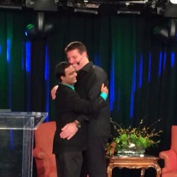 Anthony Robbins hugging Praveen Narra