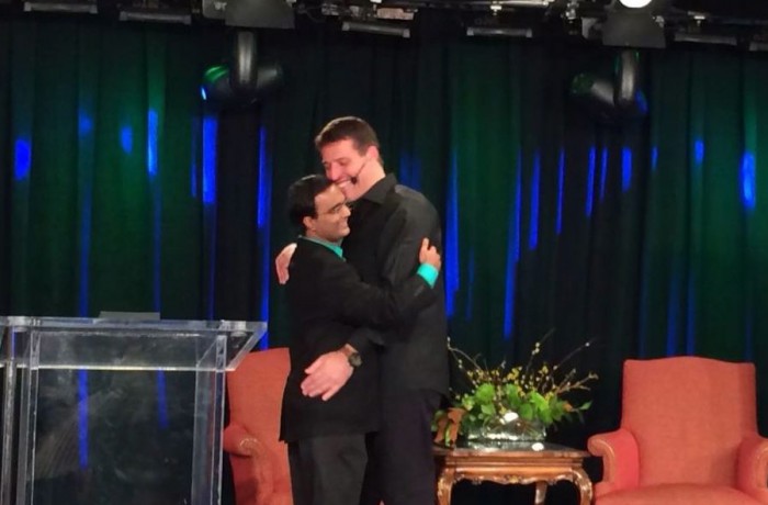 Anthony Robbins hugging Praveen Narra